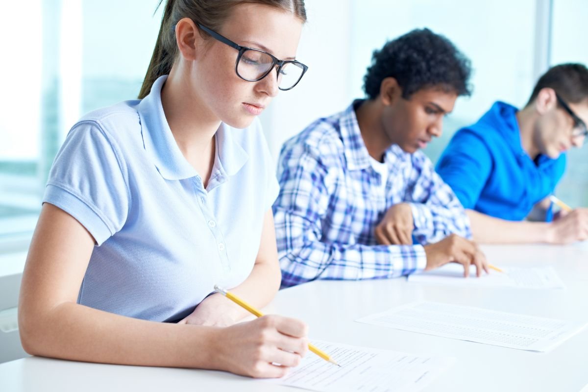 group of students writing their essays