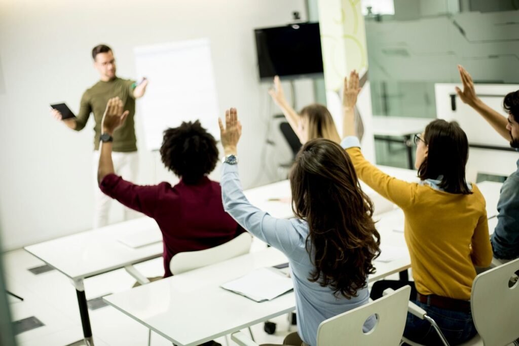 Multiple students raising their hands. 