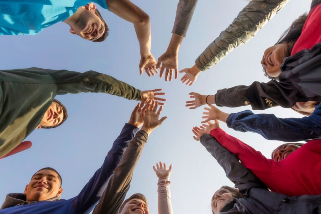 A group of people holding hands in a circle.