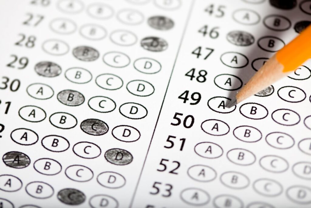 Close-up of a multiple-choice answer sheet with a pencil marking option "A" for question 49.